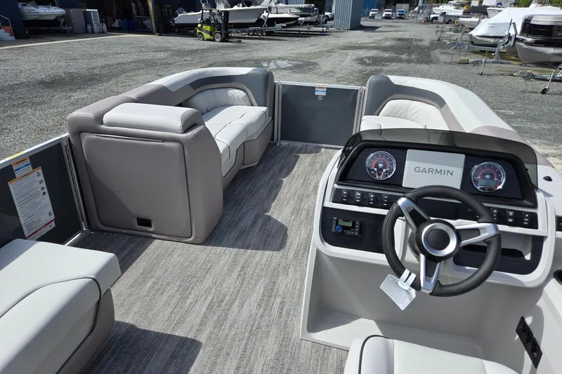 Slide: The Image of 2026 Godfrey Sweetwater 2286 FS pontoon boat interior with Garmin dashboard and plush seating. - 36