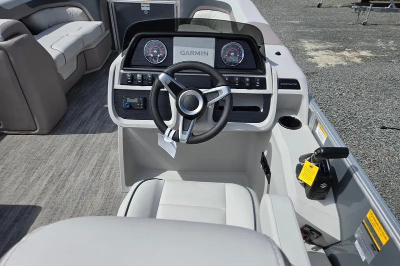Slide: The Image of 2026 Godfrey Sweetwater 2286 FS boat dashboard with Garmin navigation system and steering wheel. - 38