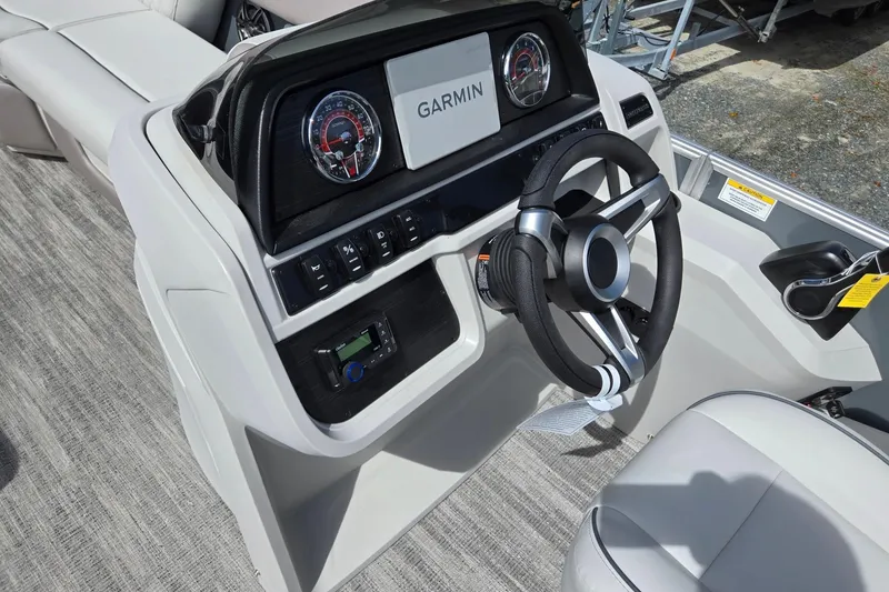 Slide: The Image of 2026 Godfrey Sweetwater 2286 FS boat dashboard with Garmin display and steering wheel. - 40