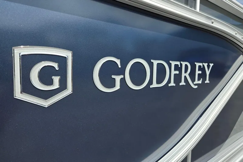 Slide: The Image of 2026 Godfrey Sweetwater 2286 FS boat logo on sleek blue surface. - 46