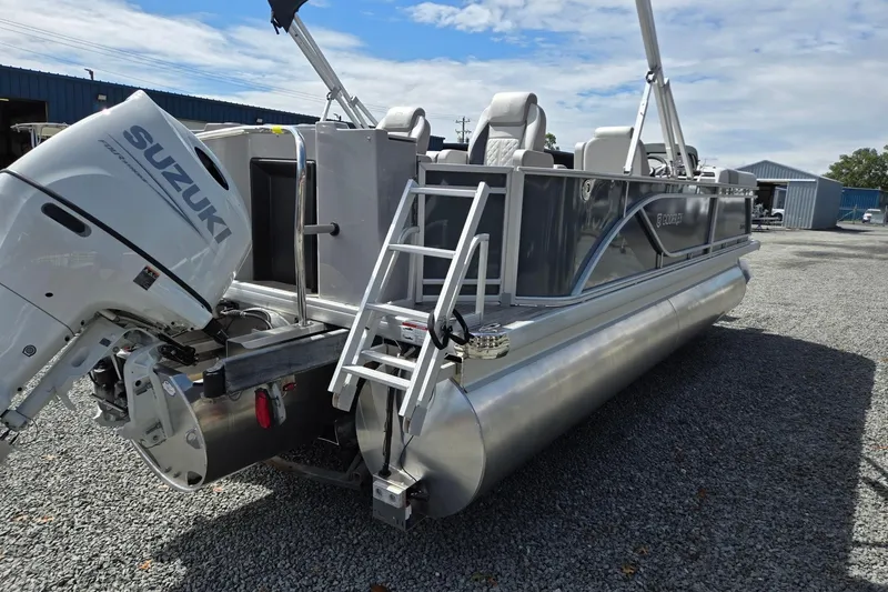 Slide: The Image of 2026 Godfrey Sweetwater 2286 FS pontoon boat with Suzuki outboard motor on gravel lot. - 5