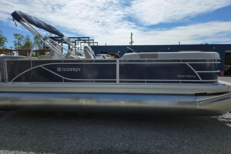 Slide: The Image of 2026 Godfrey Sweetwater 2286 FS pontoon boat with sleek design, parked outdoors. - 7