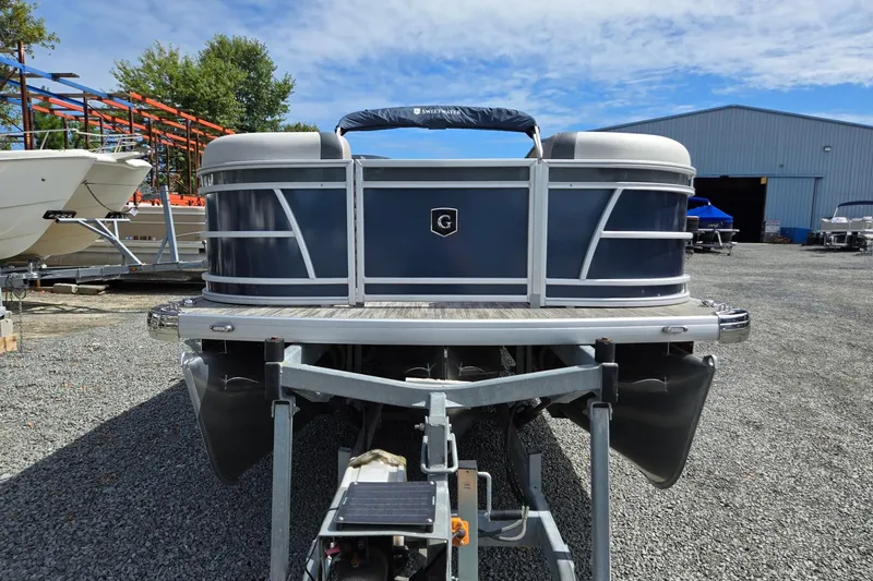 Slide: The Image of 2026 Godfrey Sweetwater 2286 FS pontoon boat on trailer, outdoor storage area. - 9