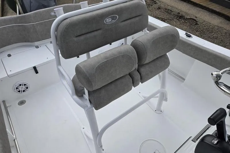 Slide: The Image of 2026 Sea Hunt Ultra 229 boat interior with cushioned seating and steering console. - 10