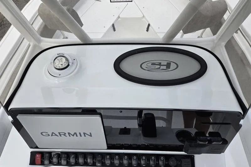 Slide: The Image of 2026 Sea Hunt Ultra 229 dashboard with Garmin navigation and compass. - 12