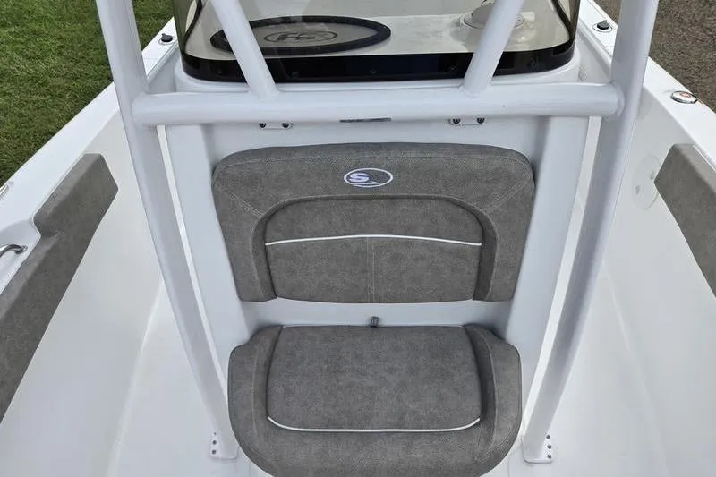 Slide: The Image of 2026 Sea Hunt Ultra 229 boat interior with gray cushioned seating and white framework. - 13