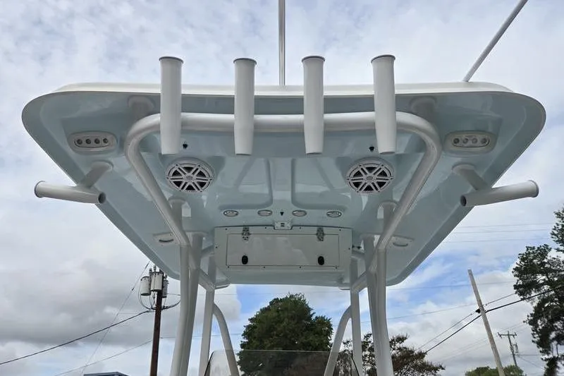 Slide: The Image of 2026 Sea Hunt Ultra 229 boat T-top with rod holders and speakers, viewed from below. - 15