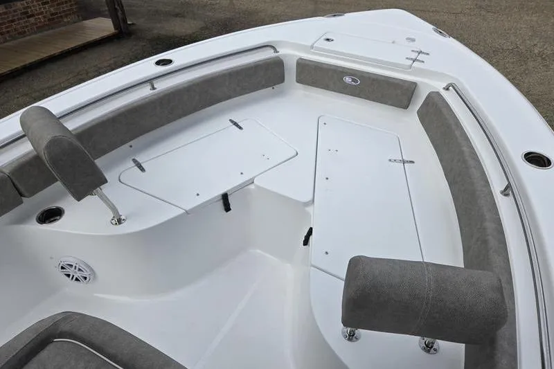 Slide: The Image of 2026 Sea Hunt Ultra 229 boat interior with cushioned seating and storage compartments. - 17