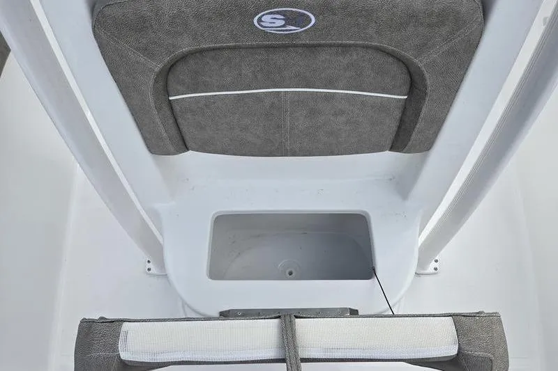 Slide: The Image of 2026 Sea Hunt Ultra 229 boat interior with gray cushioned seating and storage compartment. - 18