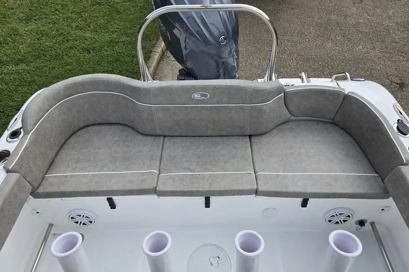 Slide: The Image of 2026 Sea Hunt Ultra 229 boat with gray cushioned seating and rod holders. - 20