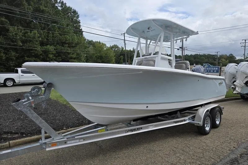 Slide: The Image of 2026 Sea Hunt Ultra 229 boat on trailer, parked outdoors. - 6