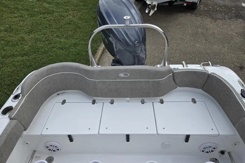 Slide: The Image of 2026 Sea Hunt Ultra 229 boat interior with cushioned seating and outboard motor. - 7