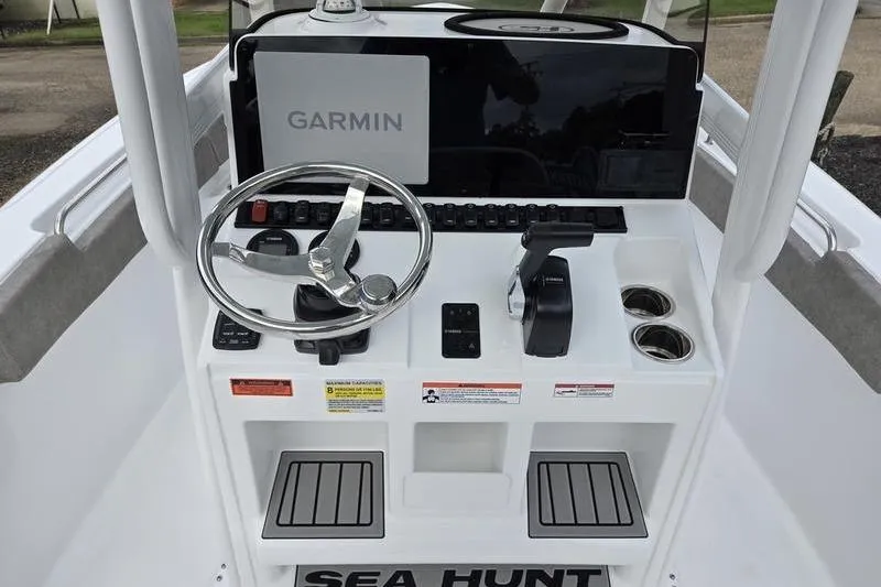Slide: The Image of 2026 Sea Hunt Ultra 229 boat console with Garmin navigation system and steering wheel. - 8