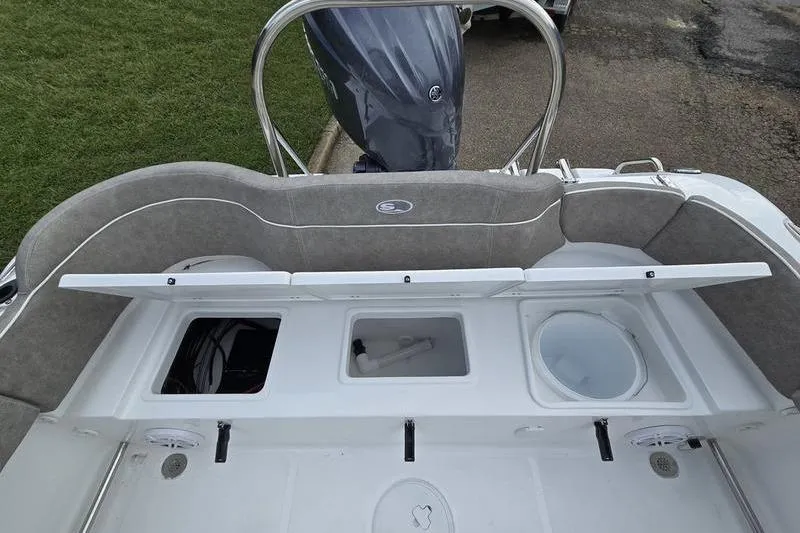 Slide: The Image of 2026 Sea Hunt Ultra 229 boat interior with storage compartments and seating. - 9