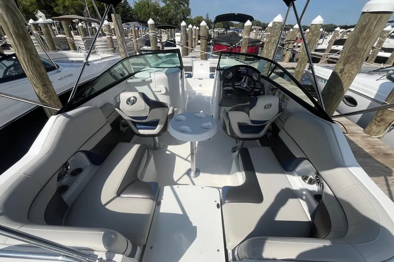 Slide: The Image of 2021 Hurricane SD 2486 boat interior with seating and steering wheel at marina. - 11