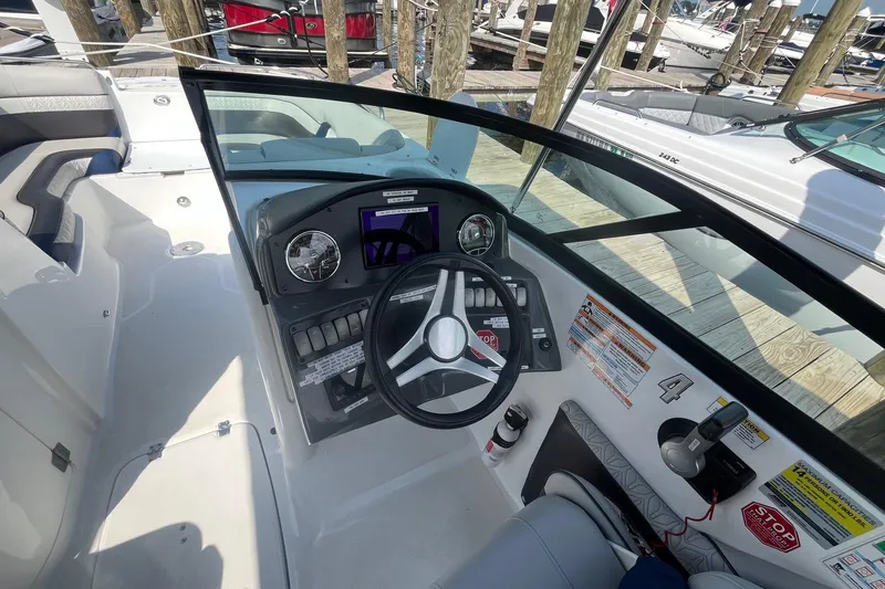 Slide: The Image of 2021 Hurricane SD 2486 boat dashboard with steering wheel and control panel. - 13
