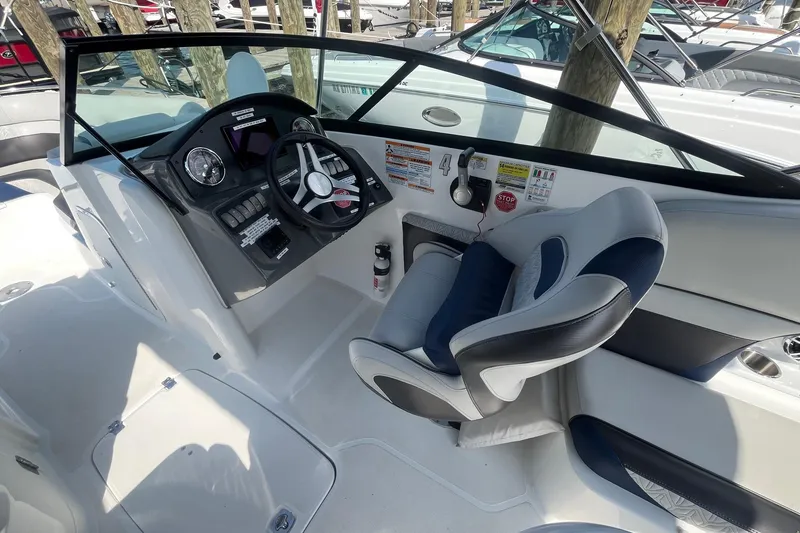 Slide: The Image of 2021 Hurricane SD 2486 boat cockpit with steering wheel and comfortable seating. - 14