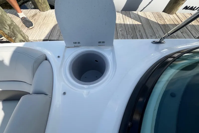 Slide: The Image of Open storage compartment on 2021 Hurricane SD 2486 boat, docked with visible seating. - 24