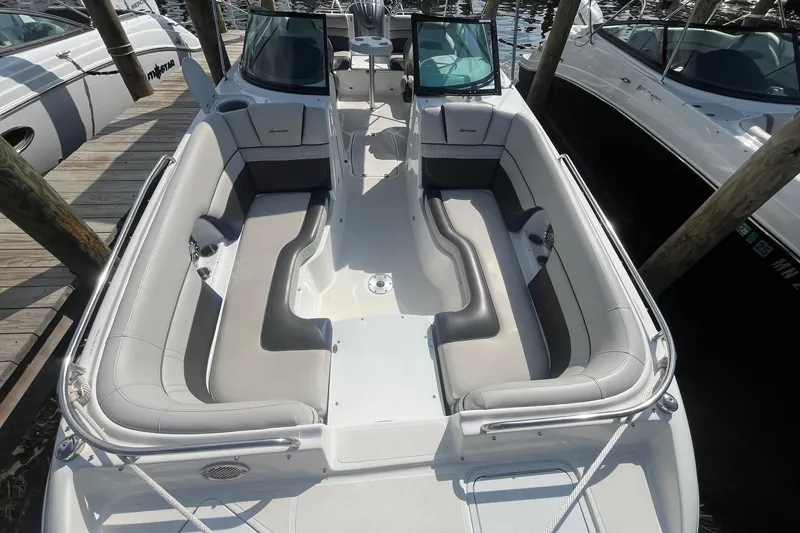 Slide: The Image of 2021 Hurricane SD 2486 boat with spacious seating, docked alongside other boats. - 26