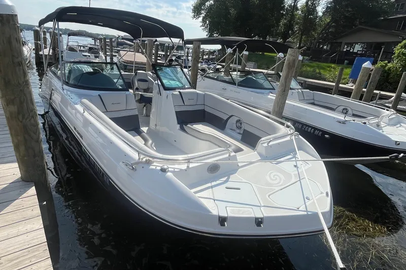 Slide: The Image of 2021 Hurricane SD 2486 boat docked, featuring sleek design and spacious seating. - 3
