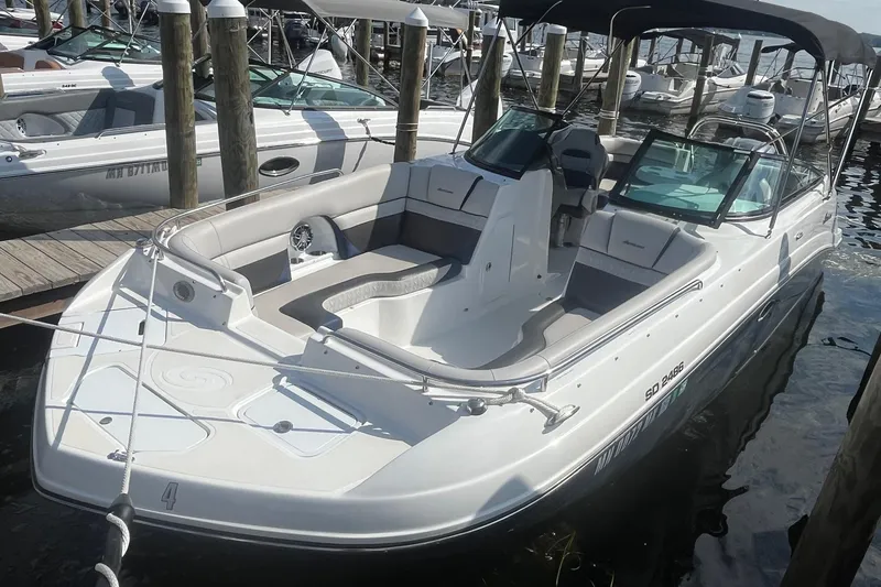 Slide: The Image of 2021 Hurricane SD 2486 boat docked, featuring spacious seating and sleek design. - 4
