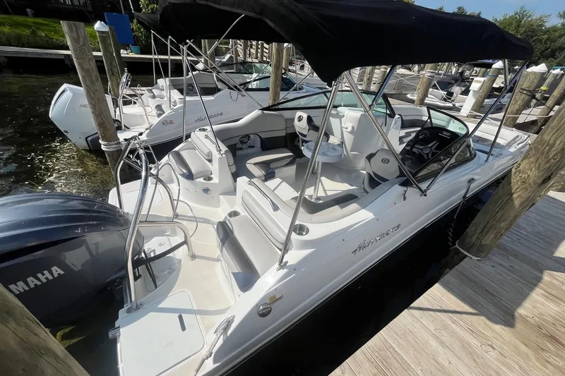 Slide: The Image of 2021 Hurricane SD 2486 boat docked, featuring a Yamaha engine and spacious seating. - 5