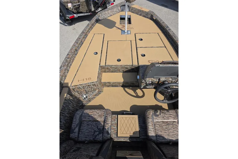 Slide: The Image of 2026 Xpress H18 Bass boat interior with camouflage design and steering console. - 13
