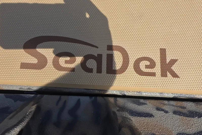 Slide: The Image of SeaDek logo on Xpress H18 Bass boat, 2026 model, textured surface. - 17