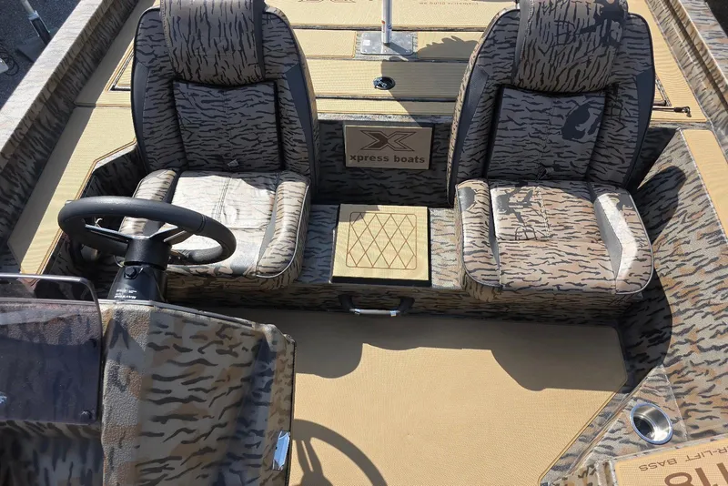 Slide: The Image of 2026 Xpress H18 Bass boat interior with camo seats and steering wheel. - 19