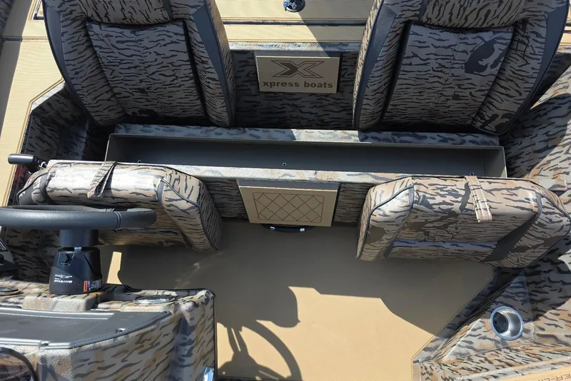 Slide: The Image of 2026 Xpress H18 Bass boat interior with camouflage seating and steering wheel. - 20