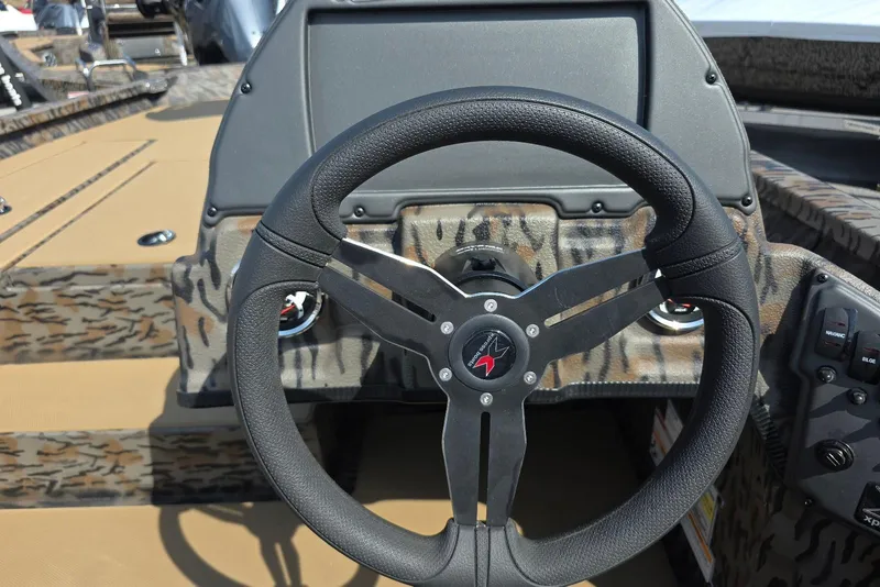 Slide: The Image of Steering wheel of 2026 Xpress H18 Bass boat with camouflage design. - 21