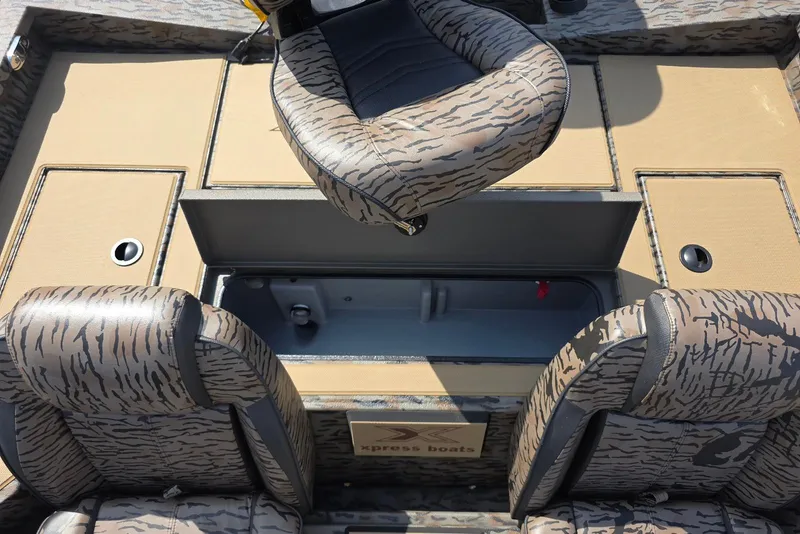 Slide: The Image of 2026 Xpress H18 Bass boat interior with camo seats and storage compartments. - 25