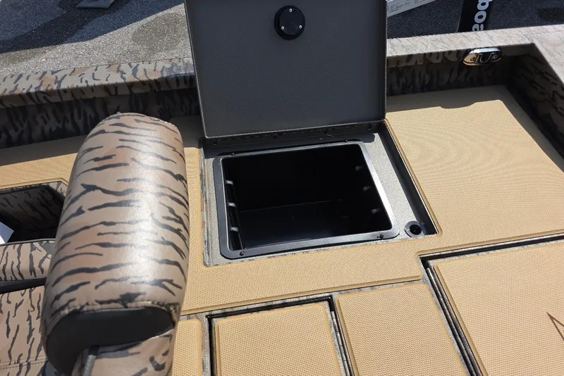 Slide: The Image of 2026 Xpress H18 Bass boat interior with open storage compartment and patterned seating. - 26