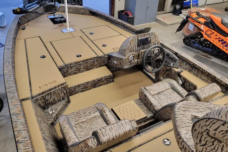 Slide: The Image of 2026 Xpress H18 Bass boat interior with camouflage design and modern controls. - 7