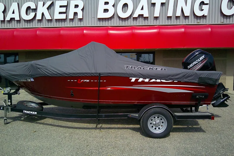 Slide: The Image of 2016 Tracker Pro Guide V-175 Combo boat with cover on trailer, outside dealership. - 2