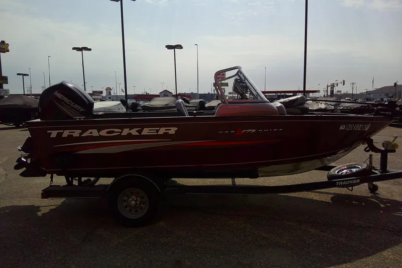Slide: The Image of 2016 Tracker Pro Guide V-175 Combo boat on trailer in parking lot. - 5