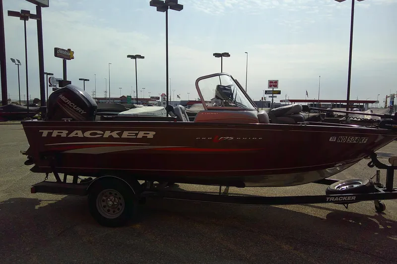 Slide: The Image of 2016 Tracker Pro Guide V-175 Combo boat on trailer in parking lot. - 6