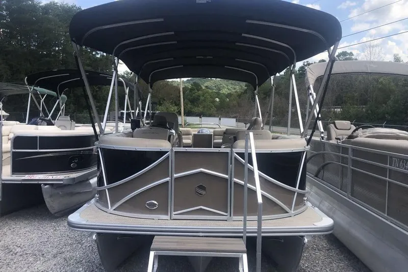 Slide: The Image of 2018 South Bay 822 CR pontoon boat with canopy, parked on gravel lot. - 3