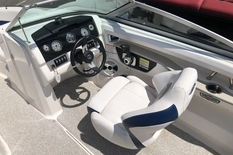 The Image of 2011 Chaparral 206 SSi boat on trailer, parked outdoors under a clear sky. - 1