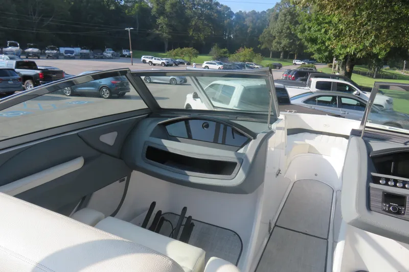 Slide: The Image of 2020 Cobalt R3 Surf boat interior with dashboard and seating, parked in a lot. - 5