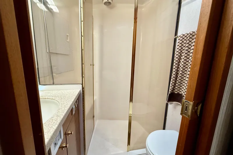 Slide: The Image of Bathroom interior of 2000 Ocean Yachts 48, featuring shower and sink. - 10
