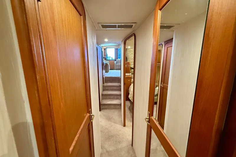 Slide: The Image of Hallway inside 2000 Ocean Yachts 48, featuring wooden doors and carpeted flooring. - 11