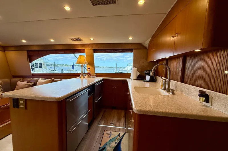 Slide: The Image of Luxurious interior of a 2000 Ocean Yachts 48, featuring a modern kitchen and scenic window view. - 16
