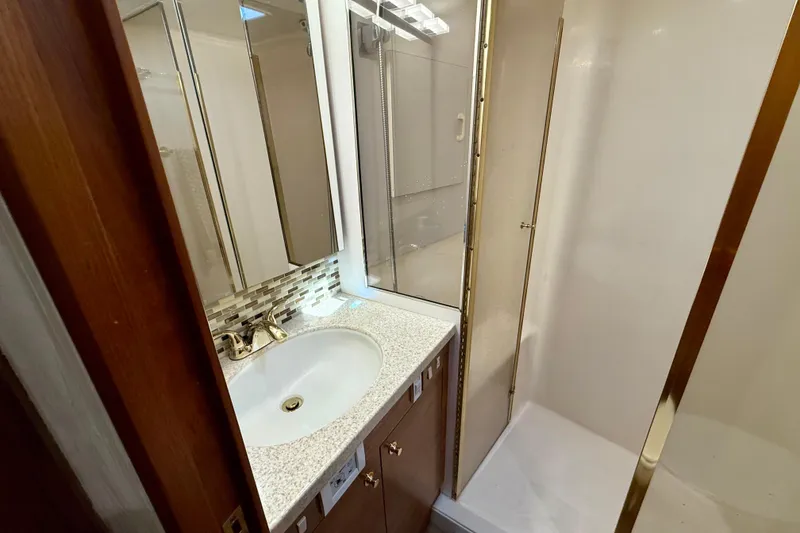 Slide: The Image of Bathroom interior of 2000 Ocean Yachts 48, featuring sink and shower. - 17