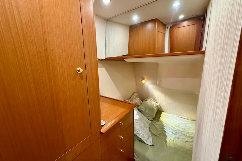 Slide: The Image of Cozy cabin interior of 2000 Ocean Yachts 48 with wooden cabinetry and soft lighting. - 18
