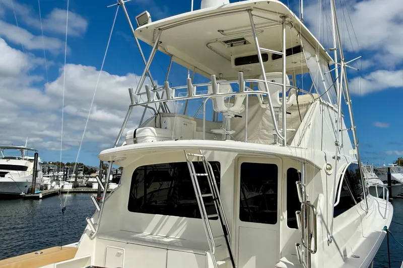 Slide: The Image of 2000 Ocean Yachts 48 docked at marina under blue sky. - 19