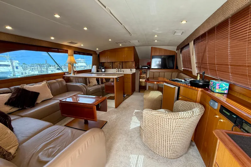 Slide: The Image of Luxurious interior of a 2000 Ocean Yachts 48, featuring plush seating and elegant wood finishes. - 2