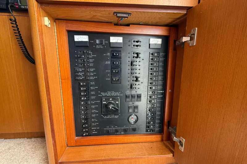 Slide: The Image of Electrical panel inside a 2000 Ocean Yachts 48, featuring switches and meters. - 20