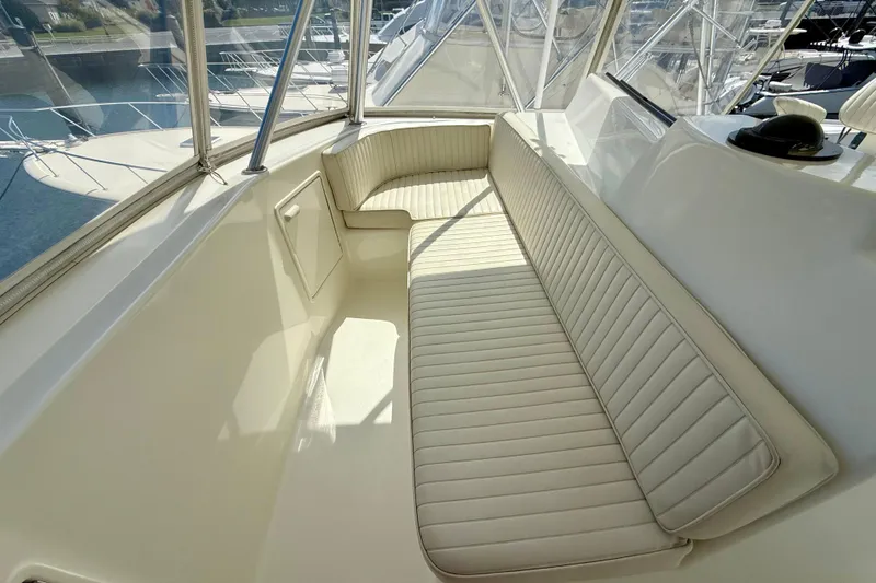 Slide: The Image of Luxurious seating area on a 2000 Ocean Yachts 48 boat, featuring cream upholstery. - 24