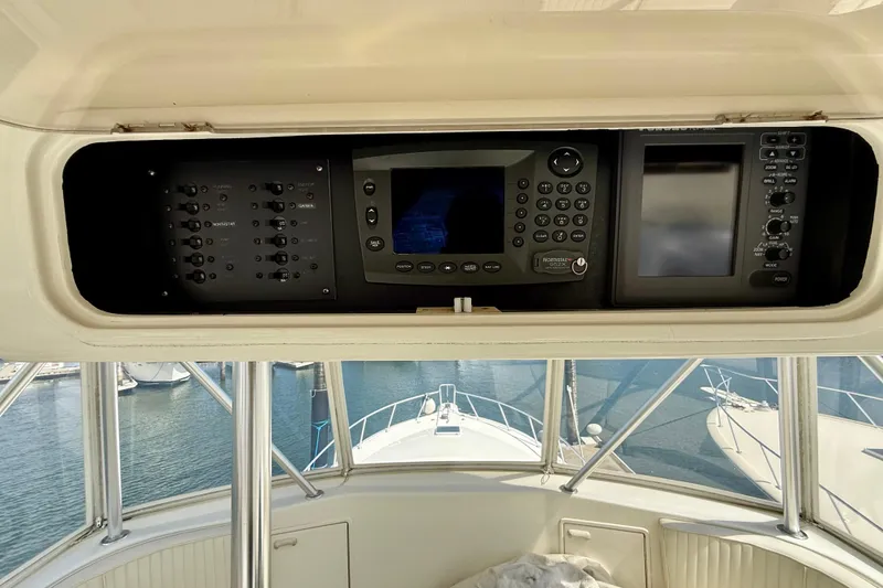 Slide: The Image of Control panel of a 2000 Ocean Yachts 48, featuring navigation and electronic systems. - 27